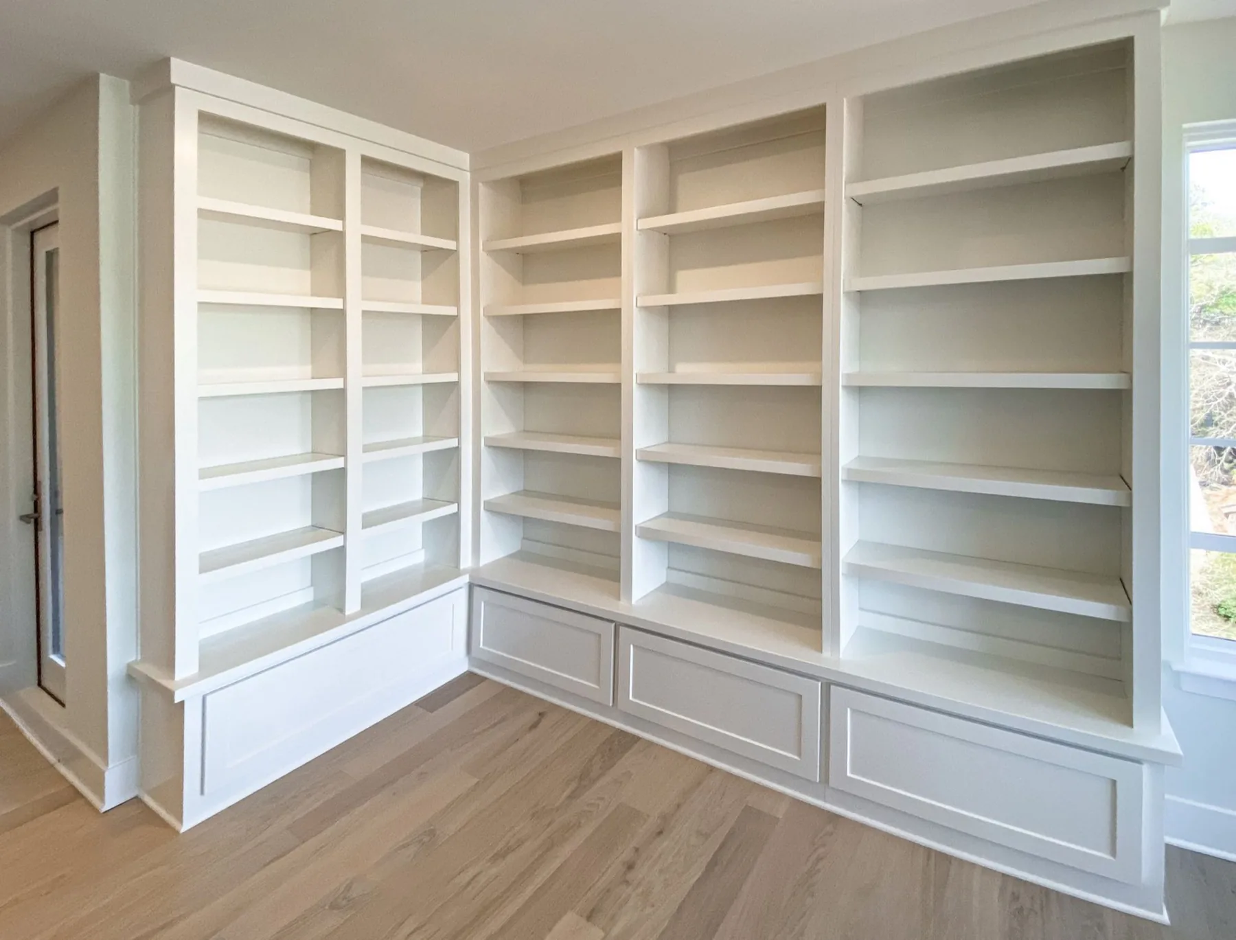 Built-in white bookcase wall
