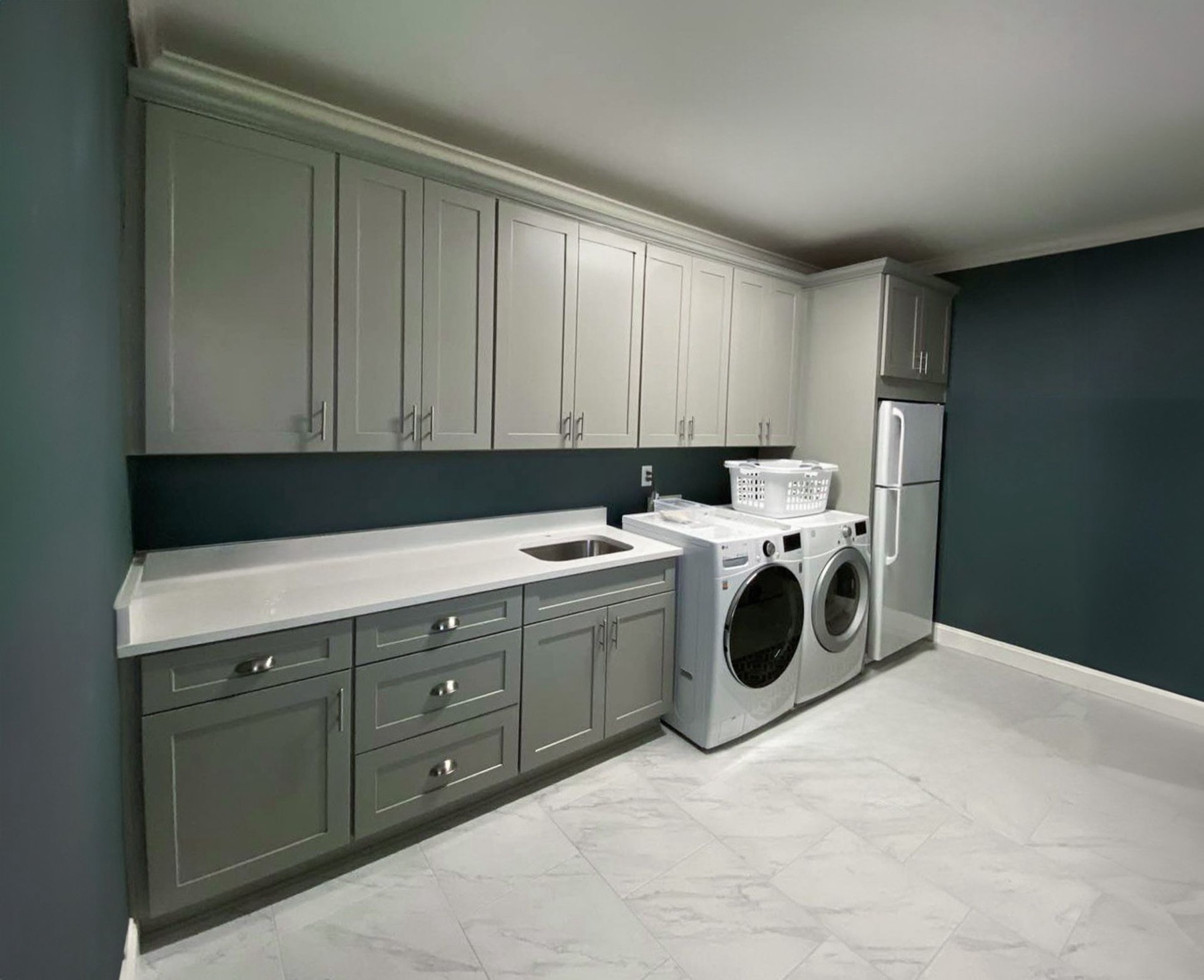 Laundry room with gray custom cabinets